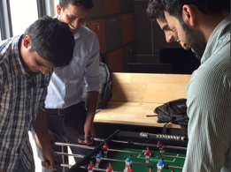 Handysolver colleagues around the foosball table